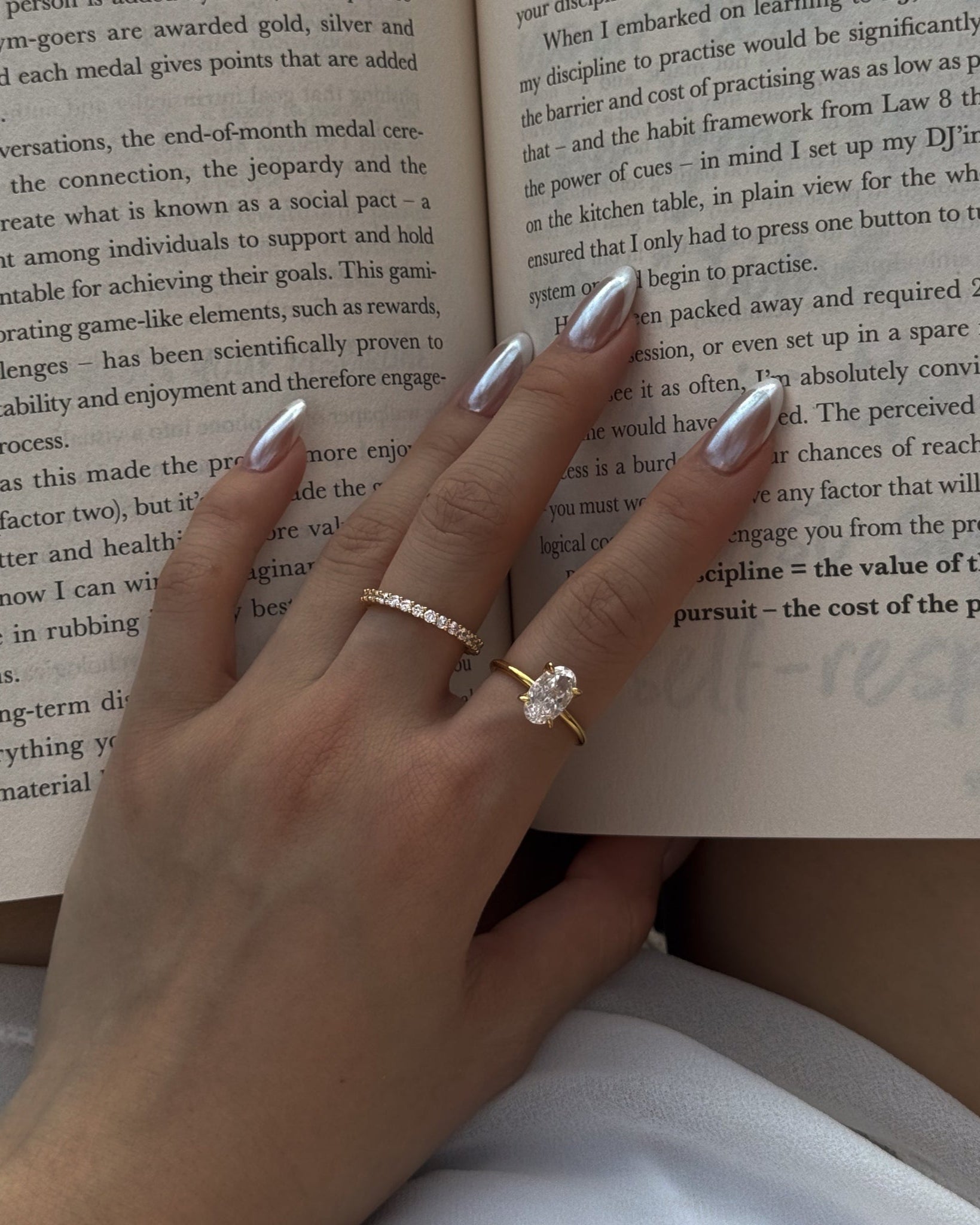 Hand with rings on an open book